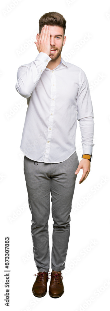 Young handsome business man covering one eye with hand with confident smile on face and surprise emotion. Young handsome business man covering one eye with hand with confident smile on face and surprise emotion.