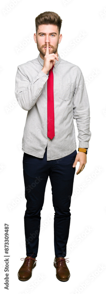 Young handsome business man asking to be quiet with finger on lips. Silence and secret concept. Young handsome business man asking to be quiet with finger on lips. Silence and secret concept.