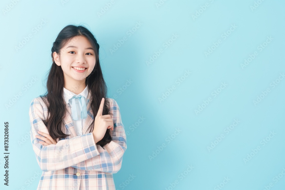 student girl finger pointing on isolated pastel background , mock up for back to school student girl finger pointing on isolated pastel background , mock up for back to school