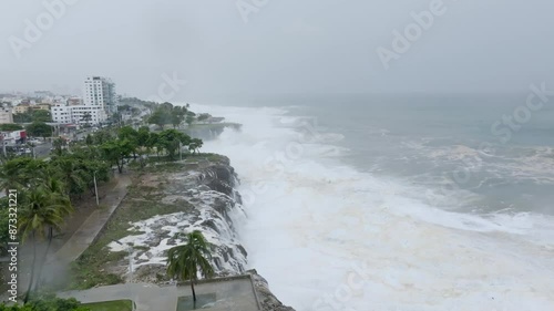 Hurricane beryl emerging strong waves of Caribbean Sea. Flooding cityscape of Dominican Republic. Aerial view. photo