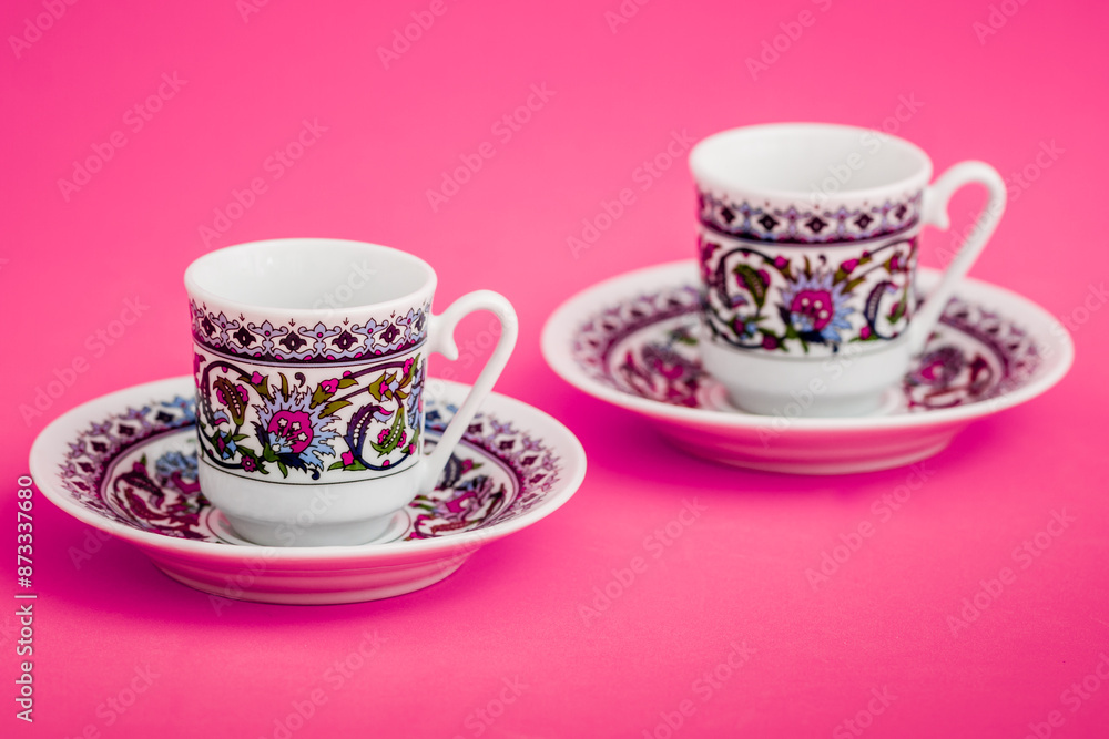 Elegant porcelain Turkish coffee cups with decorative pattern on pink background. Elegant porcelain Turkish coffee cups with decorative pattern on pink background.