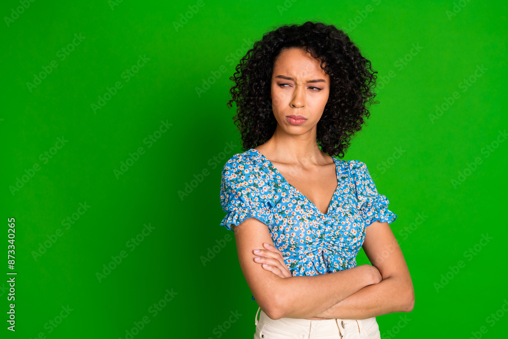 Photo of moody attractive lady wear blue blouse hands crossed looking empty space isolated green color background Photo of moody attractive lady wear blue blouse hands crossed looking empty space isolated green color background
