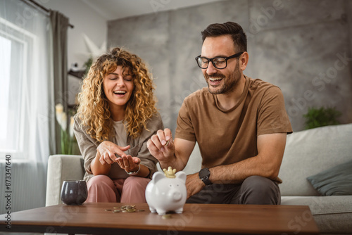 Adult couple wife and husband save money together in the piggy bank