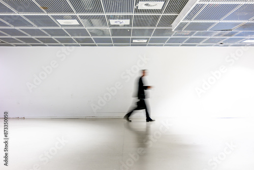 la silhouette floue d'un homme d'affaire dans un couloir blanc d'éeroport