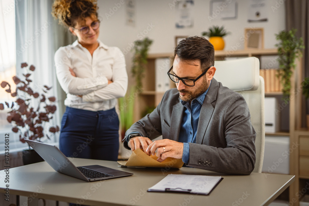 Man colleague open envelope post with woman colleague at office Man colleague open envelope post with woman colleague at office