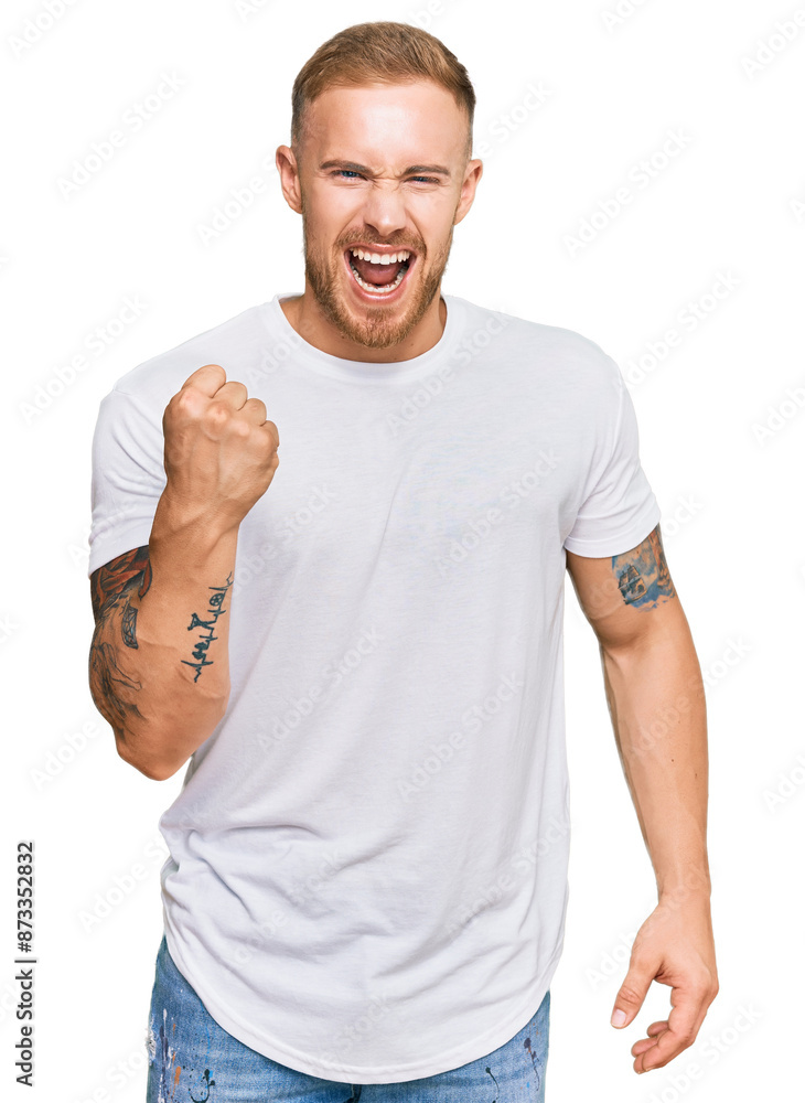 Young irish man wearing casual clothes angry and mad raising fist frustrated and furious while shouting with anger. rage and aggressive concept. Young irish man wearing casual clothes angry and mad raising fist frustrated and furious while shouting with anger. rage and aggressive concept.