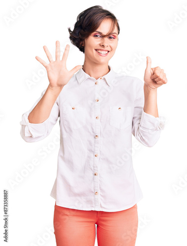 Beautiful young woman with short hair wearing elegant white shirt showing and pointing up with fingers number six while smiling confident and happy.