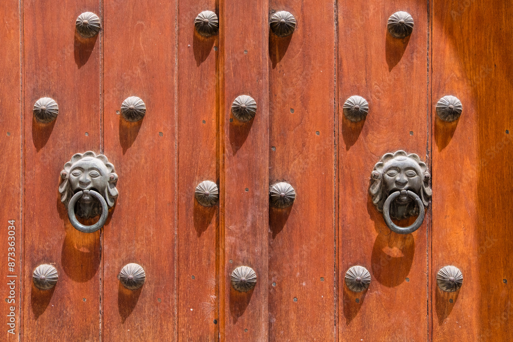 The door has a lot of decorative metal studs on it The door has a lot of decorative metal studs on it