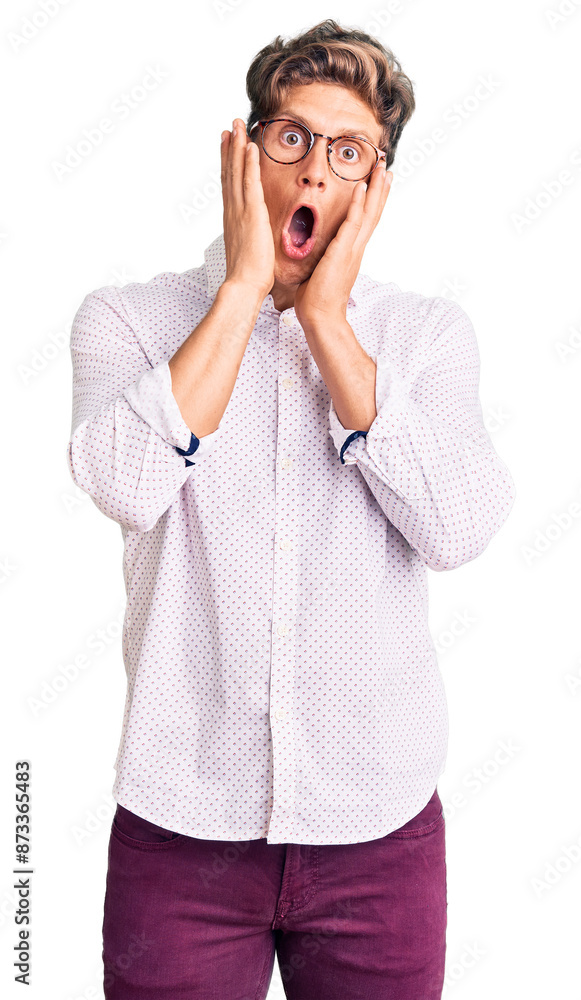 Young handsome man wearing business clothes and glasses afraid and shocked, surprise and amazed expression with hands on face Young handsome man wearing business clothes and glasses afraid and shocked, surprise and amazed expression with hands on face