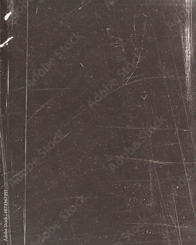 Dark maroon textured surface with scratches and marks, indicative of wear and weathering.
