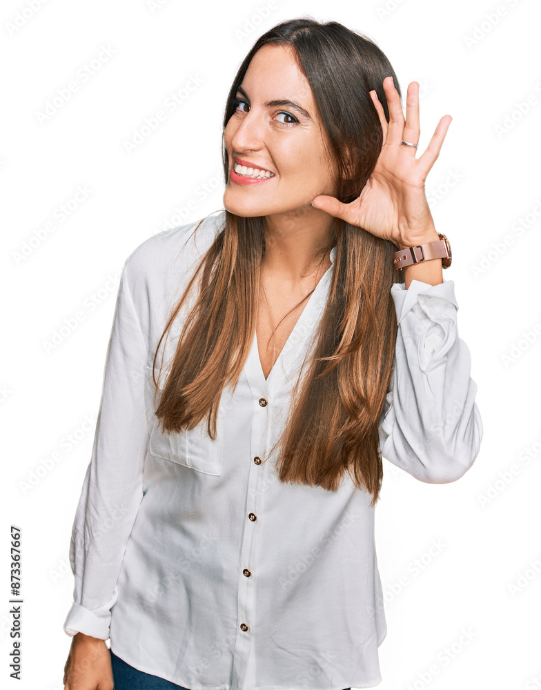 Young beautiful woman wearing casual clothes smiling with hand over ear listening an hearing to rumor or gossip. deafness concept. Young beautiful woman wearing casual clothes smiling with hand over ear listening an hearing to rumor or gossip. deafness concept.