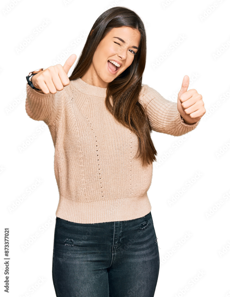 Young brunette woman wearing casual winter sweater approving doing positive gesture with hand, thumbs up smiling and happy for success. winner gesture. Young brunette woman wearing casual winter sweater approving doing positive gesture with hand, thumbs up smiling and happy for success. winner gesture.