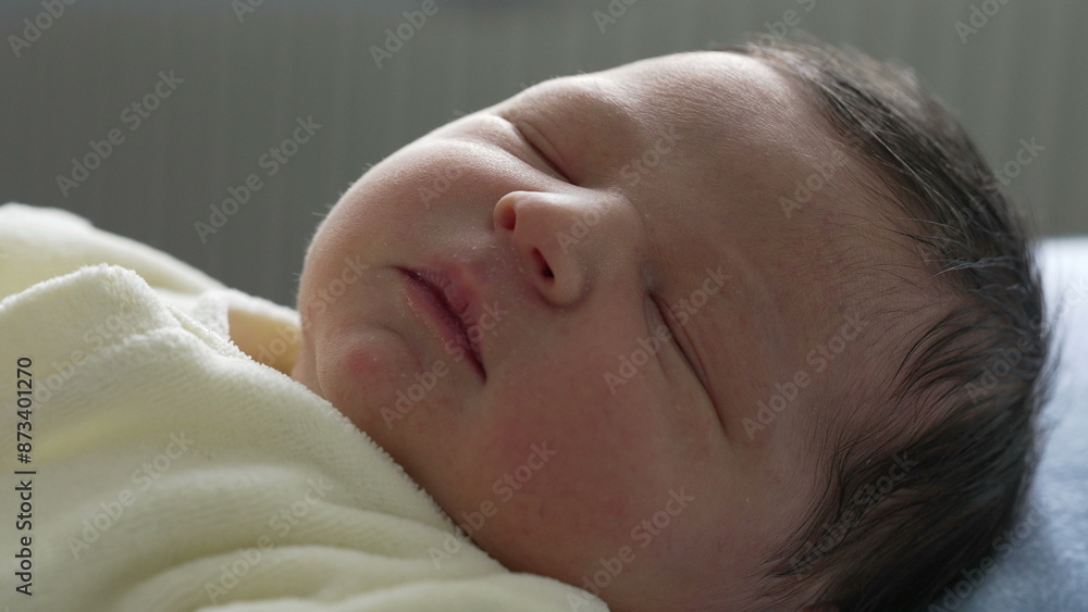 Newborn baby sleeping soundly with a calm expression, wrapped in a soft yellow blanket. close-up focuses on the baby's serene face, emphasizing the tranquility and purity of infancy Newborn baby sleeping soundly with a calm expression, wrapped in a soft yellow blanket. close-up focuses on the baby's serene face, emphasizing the tranquility and purity of infancy