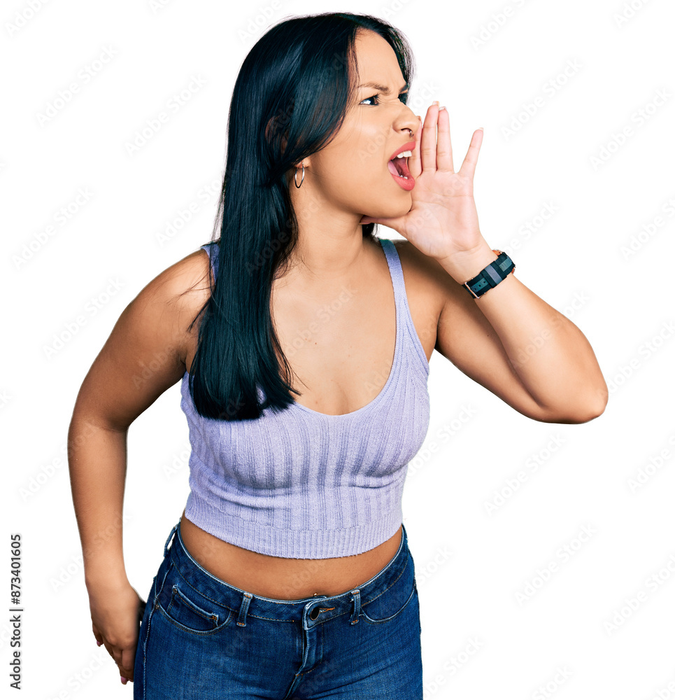 Beautiful hispanic woman wearing casual style with sleeveless shirt shouting and screaming loud to side with hand on mouth. communication concept. Beautiful hispanic woman wearing casual style with sleeveless shirt shouting and screaming loud to side with hand on mouth. communication concept.