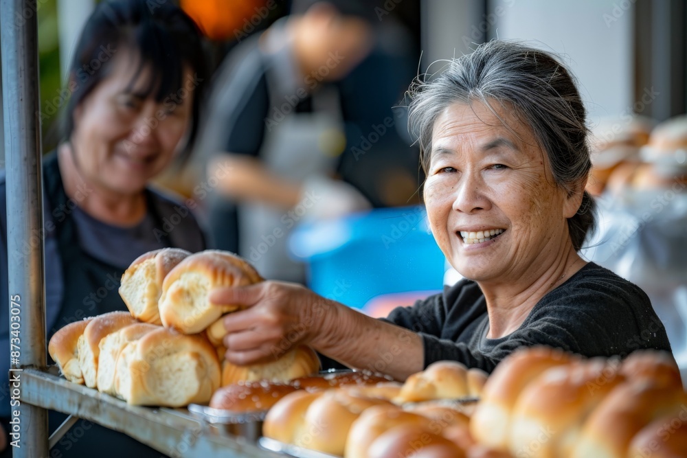 A smiling woman is holding freshly baked bread in a bakery setting, encapsulating happiness and a sense of accomplishment. Other bakery items are visible in the background. A smiling woman is holding freshly baked bread in a bakery setting, encapsulating happiness and a sense of accomplishment. Other bakery items are visible in the background.