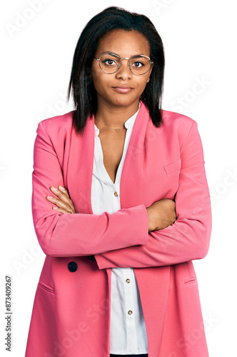 Beautiful hispanic woman with arms crossed gesture relaxed with serious expression on face. simple and natural looking at the camera.