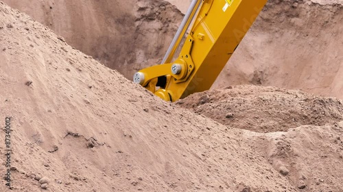 Slow motion excavator bucket shoveling dirt