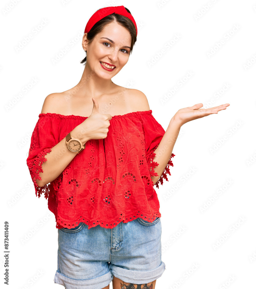 Young brunette woman with short hair wearing casual summer clothes and diadem showing palm hand and doing ok gesture with thumbs up, smiling happy and cheerful Young brunette woman with short hair wearing casual summer clothes and diadem showing palm hand and doing ok gesture with thumbs up, smiling happy and cheerful