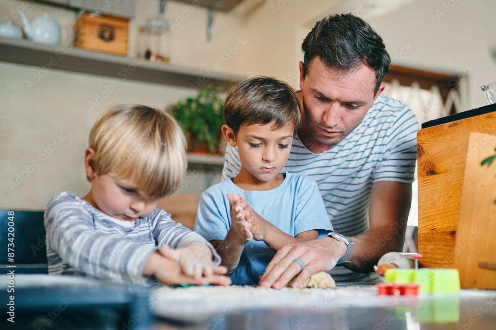 Baking, home and father with children in kitchen with ingredients for learning, bonding and recipe. Happy, family and dad with young boys with flour to bake cookies, biscuits and treats together Baking, home and father with children in kitchen with ingredients for learning, bonding and recipe. Happy, family and dad with young boys with flour to bake cookies, biscuits and treats together