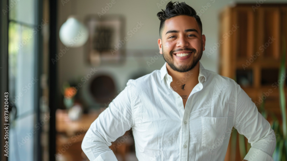 Obraz premium hispanic handsome man smiling Hands on hips while standing