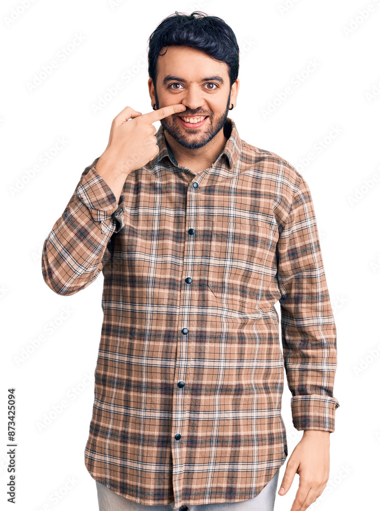 Young hispanic man wearing casual clothes pointing with hand finger to face and nose, smiling cheerful. beauty concept Young hispanic man wearing casual clothes pointing with hand finger to face and nose, smiling cheerful. beauty concept