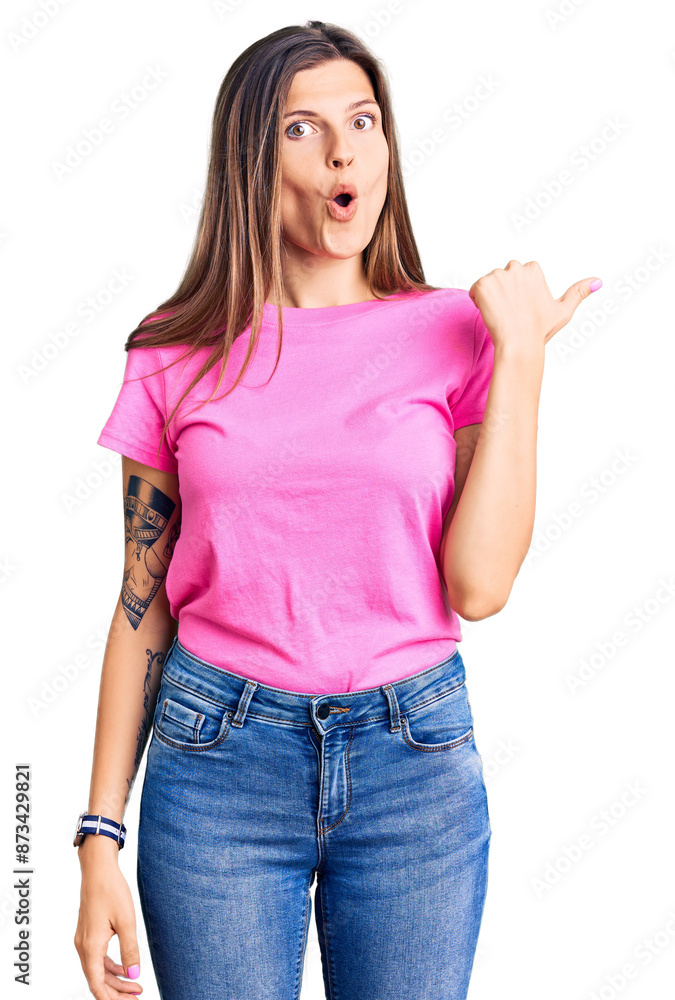 Fototapeta premium Beautiful caucasian woman wearing casual clothes surprised pointing with hand finger to the side, open mouth amazed expression.