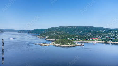 Aerial view of Tadoussac bay and Saguenay Fjord taken by drone over the St-Lawrence river. View of the Baie-Ste-Catherine, Tadoussac ferry crossing the Saguenay river.