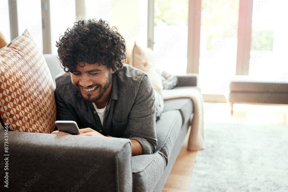 Phone, smile and man relax on sofa in home happy for mortgage approval email for goal achievement. Internet, rest and male person laying on couch with cellphone for communication on property app Phone, smile and man relax on sofa in home happy for mortgage approval email for goal achievement. Internet, rest and male person laying on couch with cellphone for communication on property app