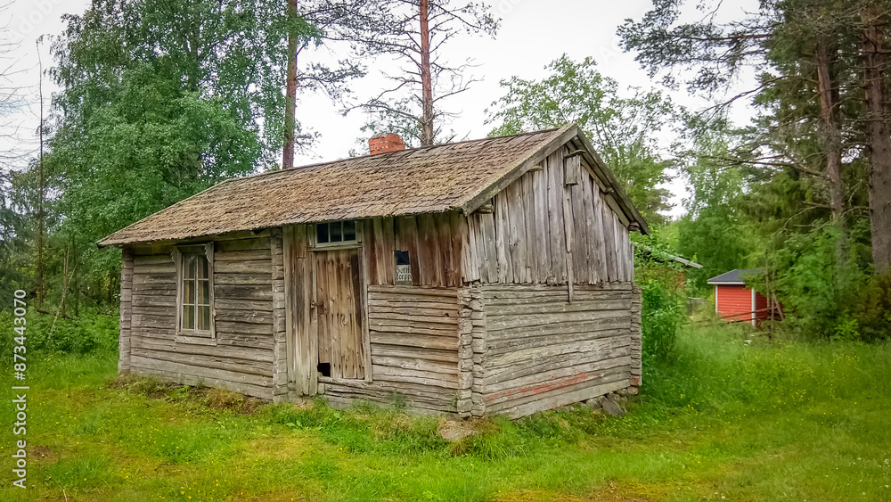 Ancient wooden hut surrounded by greenery in Finland Ancient wooden hut surrounded by greenery in Finland