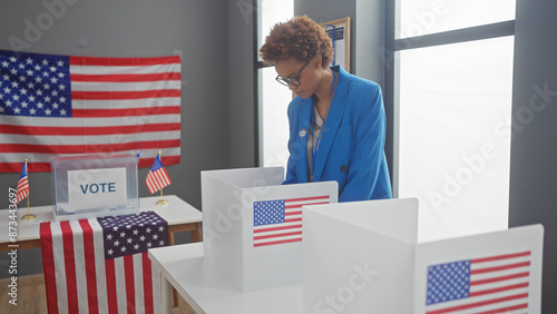 African american woman voting in u.s. election with flag backdrop photo