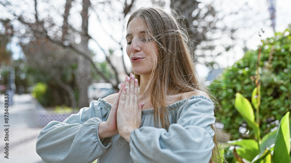 A young woman practices yoga in a serene outdoor park environment, exuding peace and wellness. A young woman practices yoga in a serene outdoor park environment, exuding peace and wellness.