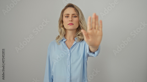 Wallpaper Mural A young blonde woman in a blue shirt gestures stop against a white background. Torontodigital.ca