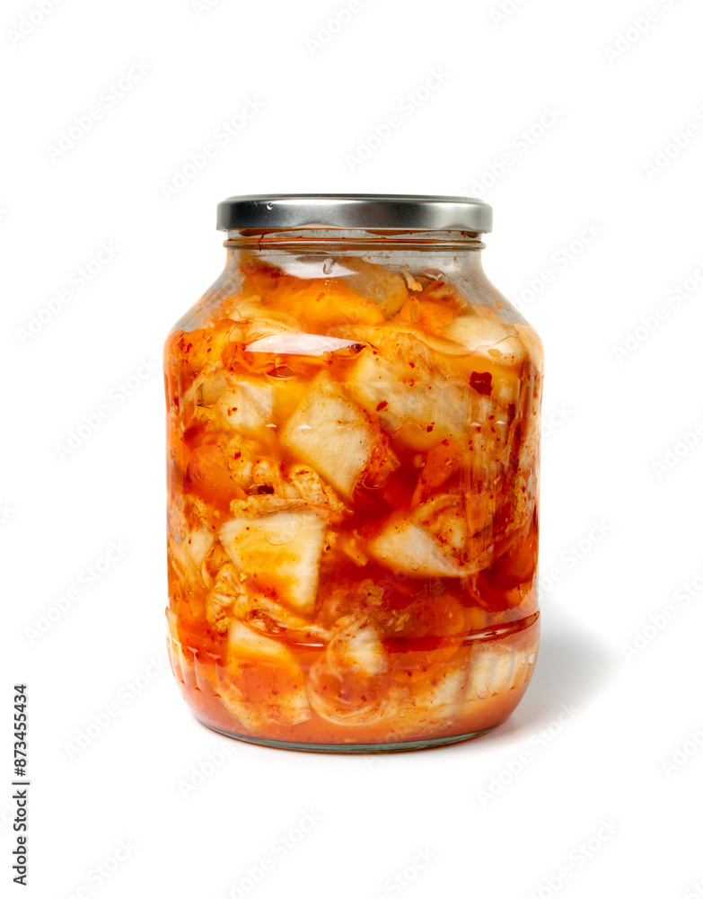 Kimchee in a glass jar isolated. Spicy kim chi, hot fermented napa cabbage, jimchi, korean gimchi Kimchee in a glass jar isolated. Spicy kim chi, hot fermented napa cabbage, jimchi, korean gimchi