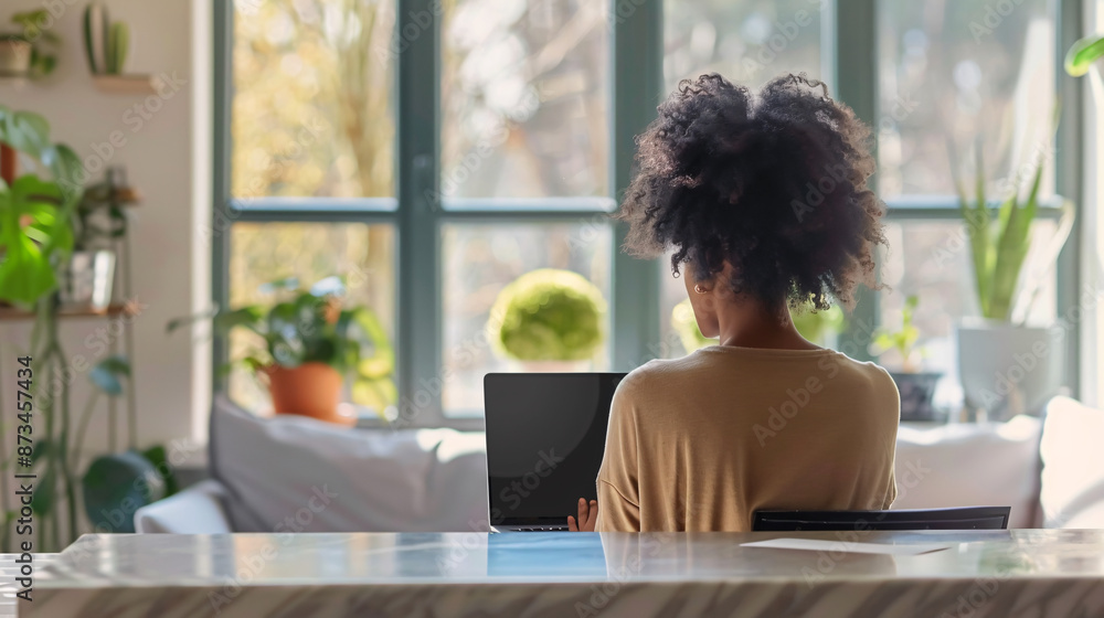 Woman working from home using a laptop screen mockup Woman working from home using a laptop screen mockup
