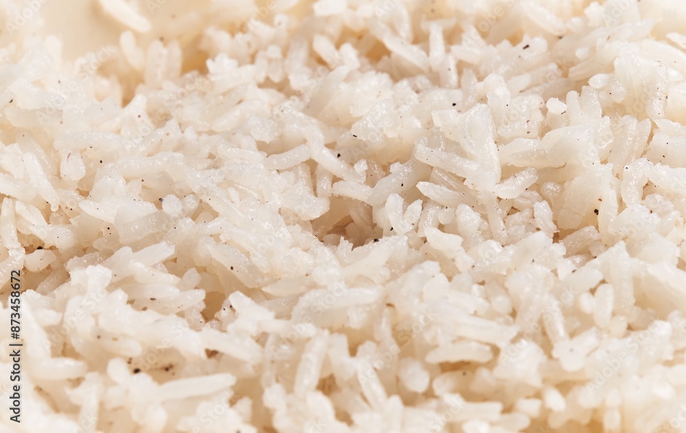 Close-up view of steamed white rice, showcasing its texture and individual grains in a culinary context. Close-up view of steamed white rice, showcasing its texture and individual grains in a culinary context.