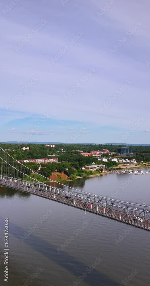 Vertical aerial video of the Franklin Delano Roosevelt Mid-Hudson Bridge over the Hudson River, Poughkeepsie NY.  