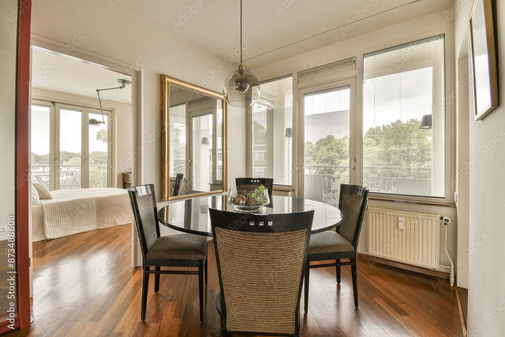 Modern dining room with natural light and balcony access Modern dining room with natural light and balcony access
