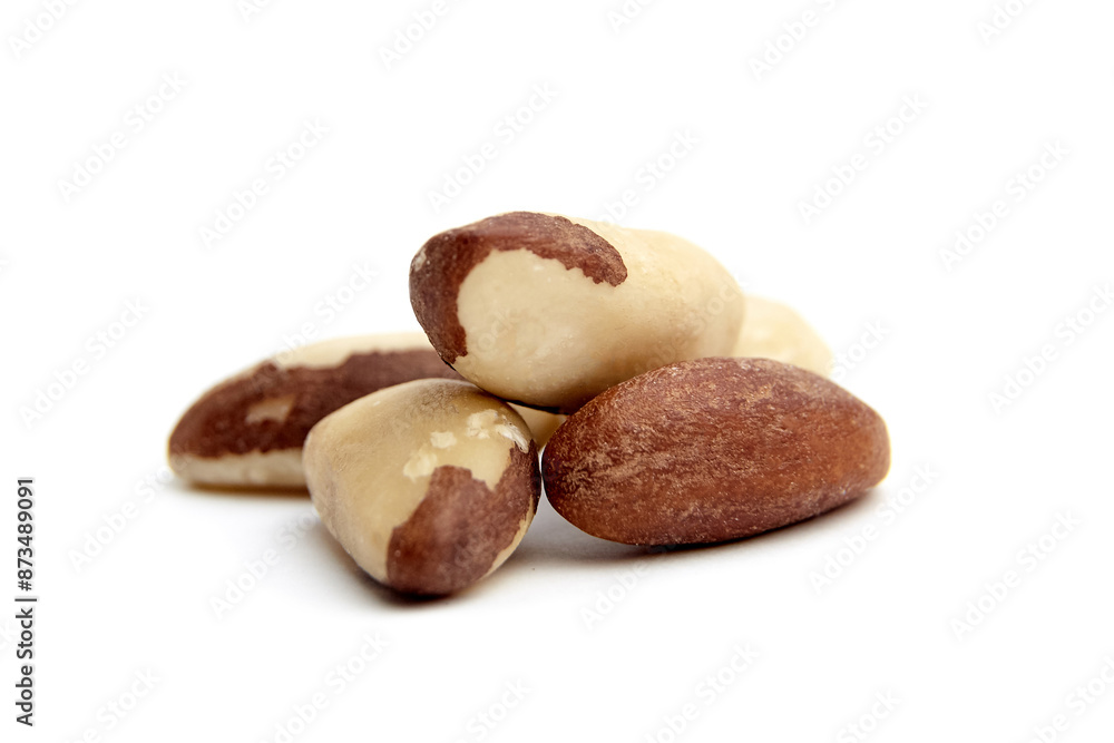 Close-up of several Brazil nuts isolated on a white background. Ideal for illustrating healthy eating, snacks, and nutrition Close-up of several Brazil nuts isolated on a white background. Ideal for illustrating healthy eating, snacks, and nutrition