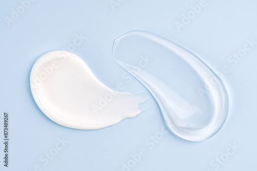 Cosmetic smears of cream presented on a blue background