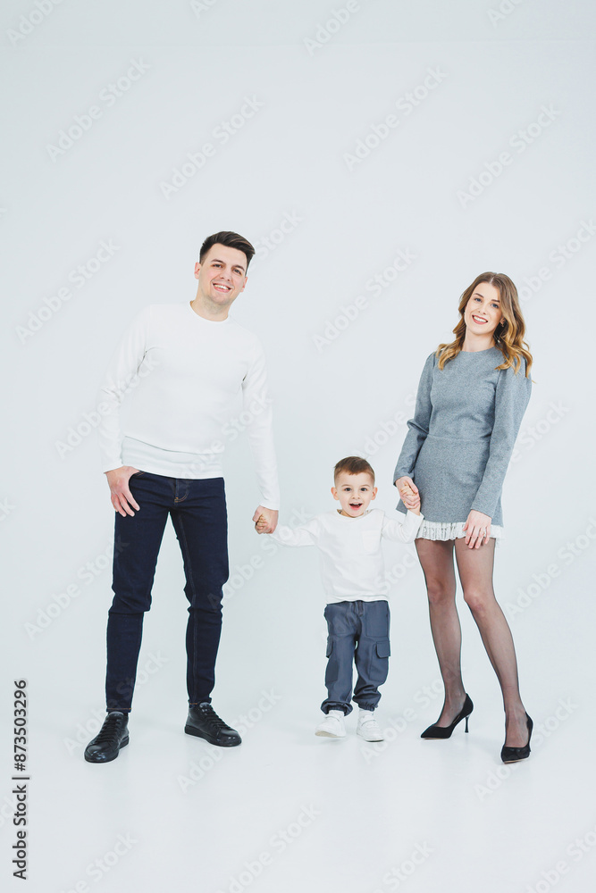 A happy married couple with a little son. Mom, dad and smiling son. Stylish family. A happy married couple with a little son. Mom, dad and smiling son. Stylish family.