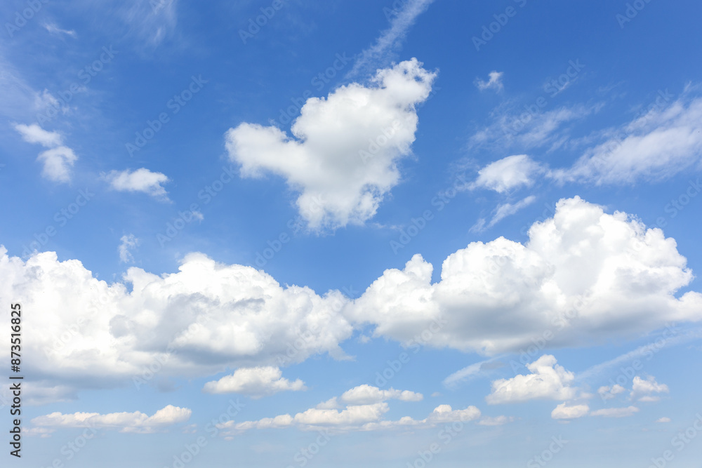 Obraz premium Natural beautiful abstract scenic azure blue sky with white cumulus clouds background on bright sunny summer day. Nature cloudscape tranquil landscape scene backdrop pattern