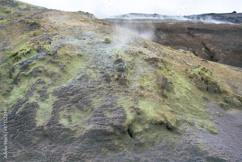 Steam vents and fumaroles. Volcanic soil in Námafjall. Hydrothermal phenomena, cracks in the ground, emanation of geothermal vapours. photo