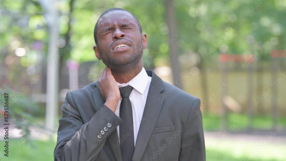 Portrait of African Businessman with Neck Muscle Pain Outdoor Portrait of African Businessman with Neck Muscle Pain Outdoor
