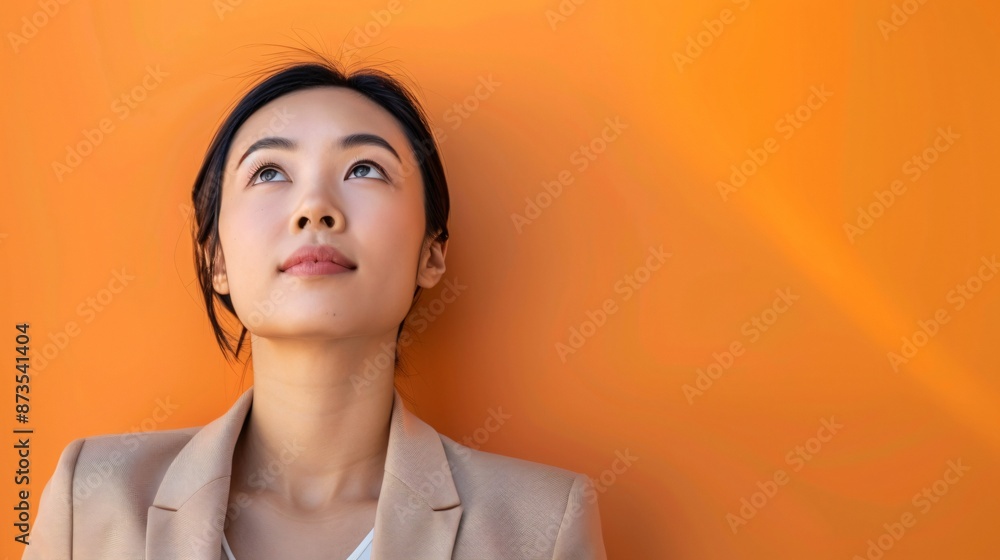 Asian businesswoman with black hair, elegant and softly luminous, orange background, 32k uhd Asian businesswoman with black hair, elegant and softly luminous, orange background, 32k uhd