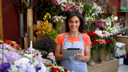 Happy, young woman operating her own flower store