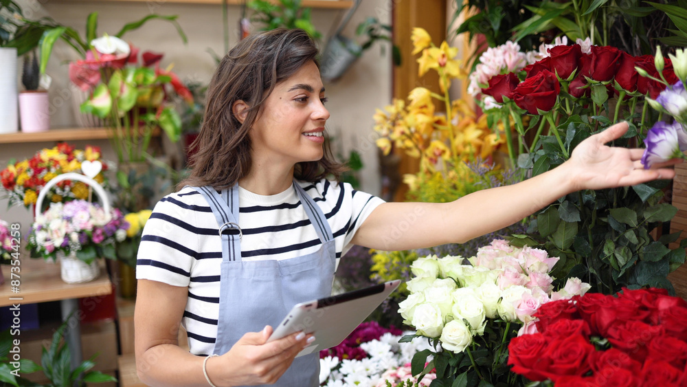 Smiling florist enjoying while running her business Smiling florist enjoying while running her business