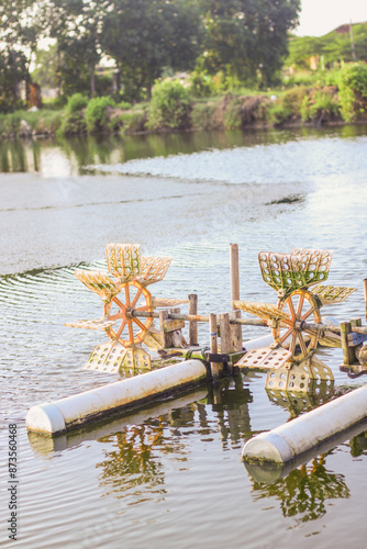 closeup of shrimp pond cultivation using hydraulic turbine water paddle wheel aerators