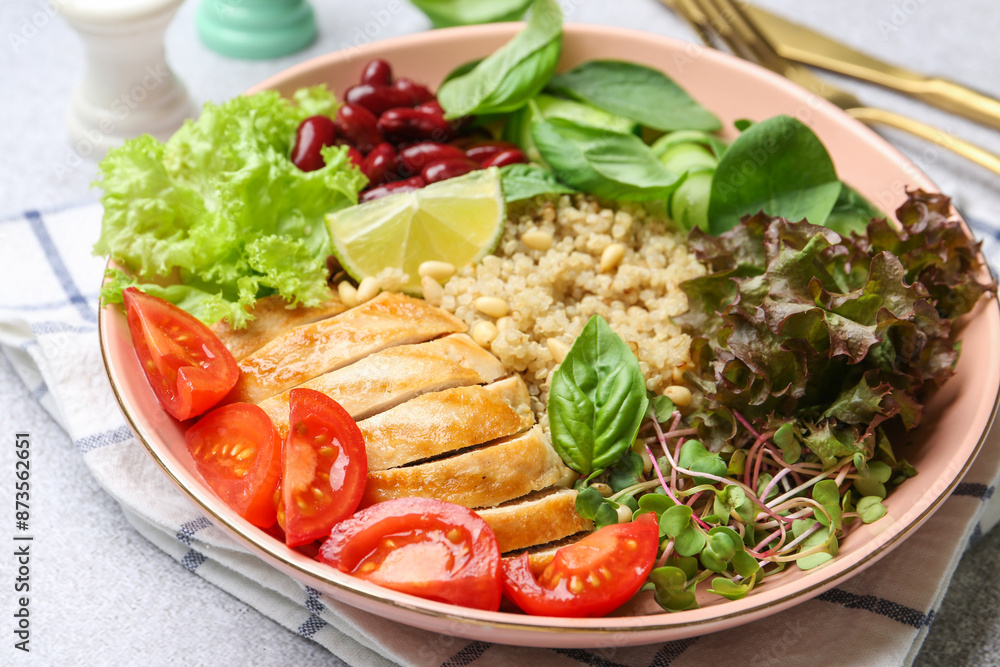 Healthy meal. Tasty vegetables, quinoa and chicken breast in bowl on white table, closeup Healthy meal. Tasty vegetables, quinoa and chicken breast in bowl on white table, closeup