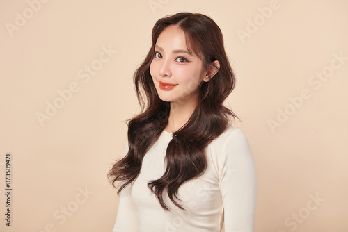 Beautiful young asian woman with clean fresh skin on beige background, Face care, Facial treatment, Cosmetology, beauty and spa, Asian women portrait. © kitthanes