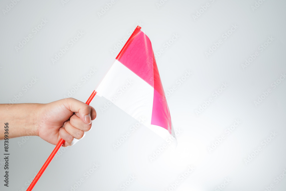 hands waving the flag excited to celebrate Indonesia's independence day on August 17